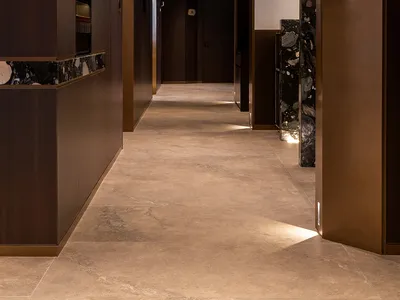 Modern hotel hallway with marble, wood, concrete flooring and ceiling lights