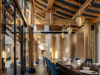 Industrially styled restaurant interior with bamboo elements
