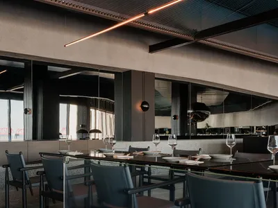 A modern industrial restaurant interior with concrete, glass, and metal materials