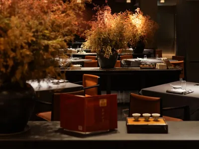 Industrial-themed restaurant interior featuring wood, glass, and metal elements.