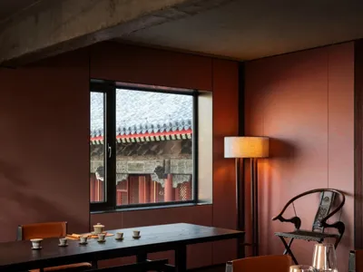 Modern interior with wooden tables and chairs in a restaurant setting.