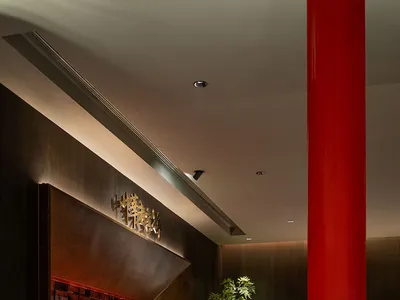 A modern restaurant interior featuring metal, wood, and marble elements.
