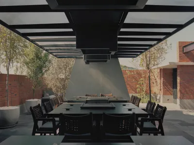 View of a modern restaurant exterior featuring glass, concrete, and steel