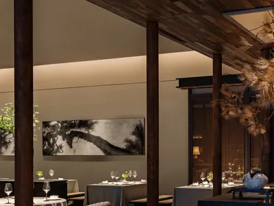 A modern restaurant interior featuring wooden elements and contemporary design.