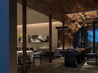Modern restaurant interior with wooden furniture and decor, featuring a minimalist design with clean lines and natural materi