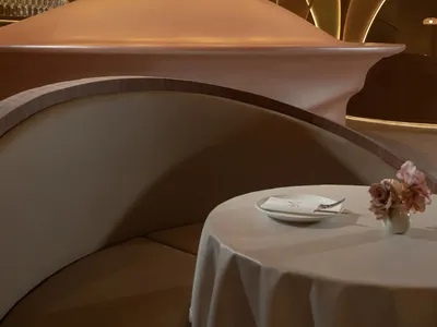 A modern restaurant interior with metallic architectural elements and futuristic design.