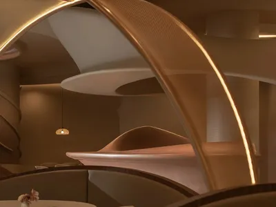 A modern restaurant dining room with metal arc lighting fixtures.