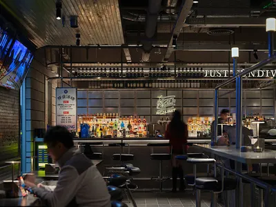A modern bar counter made of metal and glass materials.
