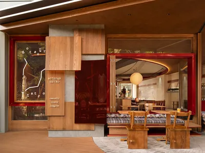 A modern restaurant interior featuring wooden elements and a cozy atmosphere.