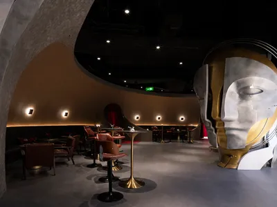 A modern restaurant interior showcasing metal and concrete materials