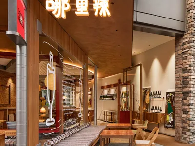 Industrial-themed restaurant interior with wooden furniture and modern design elements.
