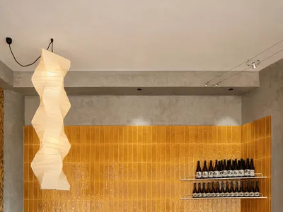 Modern restaurant interior design featuring warm colors and wooden furniture.