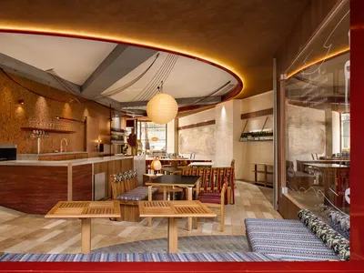 A modern restaurant interior featuring wooden furniture and a warm, inviting atmosphere.