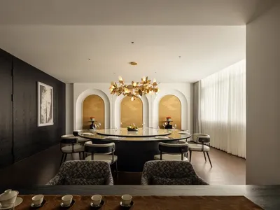 A modern restaurant featuring metal, glass, marble, and wood materials.