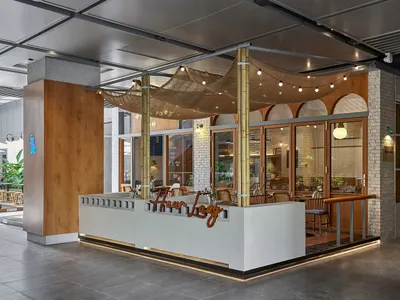 A modern industrial Scandinavian restaurant exterior featuring natural materials such as wood, concrete, and brick.