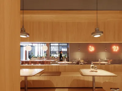 A modern coffee shop interior with wooden elements and hanging lamps.