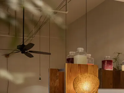 Industrial style restaurant interior with metal and wooden furniture and decor.