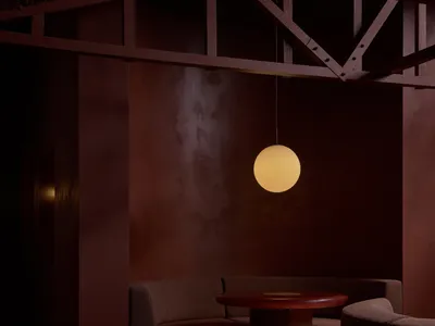 Circular tables and seating with modern interior design elements in a restaurant bar setting.