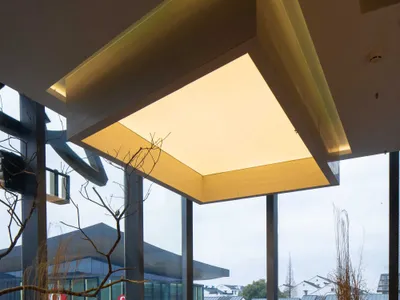 Modern restaurant interior featuring a contemporary design with concrete walls and seating.