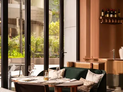 A modern restaurant interior with contemporary furniture and seating options.