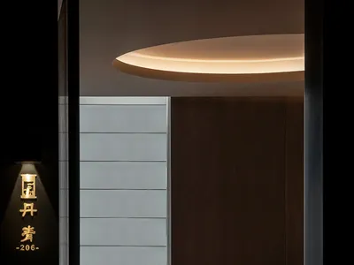 A modern dining room with dark wood and glass elements, featuring a round table set for eight people.