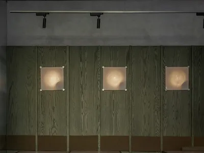 Modern industrial-style restaurant interior with wooden paneling and seating.