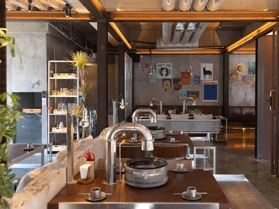 Industrial design restaurant interior with metal elements, glass, and concrete