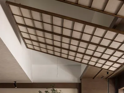 這張照片展示了一間現代餐廳的室內空間，採用極簡設計，搭配木質家具、一棵樹以及當代元素。