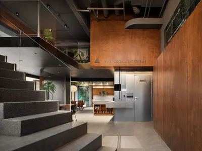 Industrial-style restaurant interior featuring concrete, wood, and metal materials