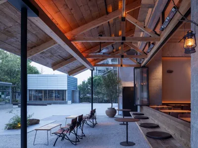 An indoor restaurant with wooden elements and a rustic atmosphere.