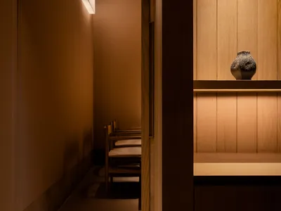 Modern restaurant space featuring wooden materials and minimalist design.