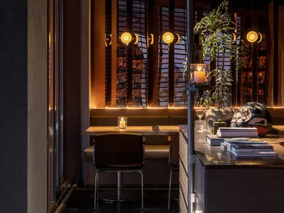 Industrial-themed restaurant interior featuring metal, wood, glass, and concrete materials.