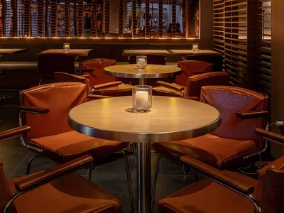 An industrial-style restaurant interior with wooden furniture and warm lighting.