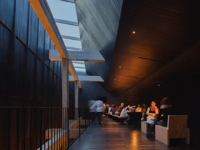Interior of a modern restaurant featuring concrete and wooden elements