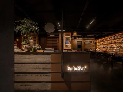 A modern restaurant bar with wooden accents and a warm, inviting atmosphere.