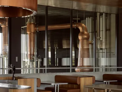 A modern restaurant bar featuring copper and wooden materials.
