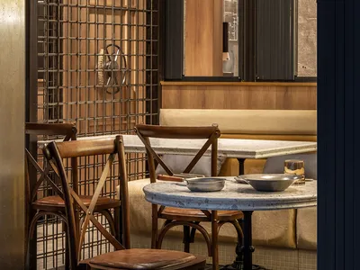 Industrial-themed restaurant interior with wood and concrete materials.