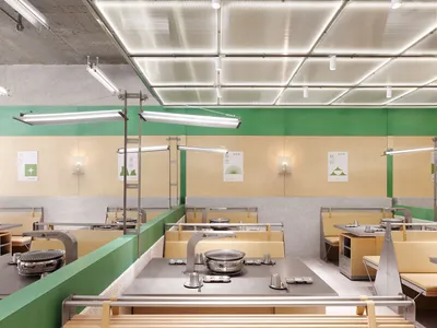 Industrial-style restaurant interior featuring steel countertops and modern fixtures.