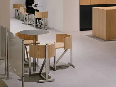 A modern minimalist restaurant with wooden furniture and seating