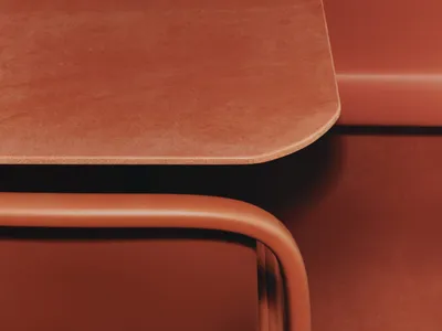 A close-up view of a modern restaurant booth upholstered in leather and cork material, featuring an integrated tabletop surfa