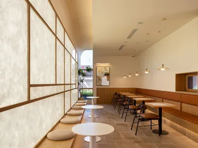 Modern cafe interior with wooden furniture and seating areas