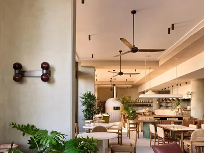 Modern restaurant interior with concrete and wooden features.