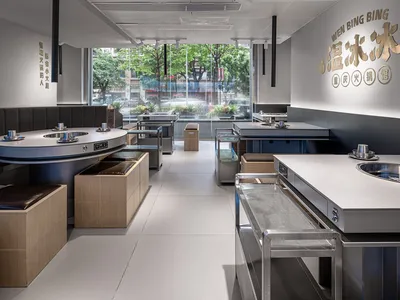 Modern restaurant interior with metallic tables and industrial design elements