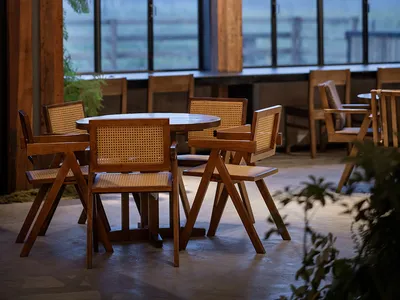 A modern restaurant interior featuring wooden furniture.