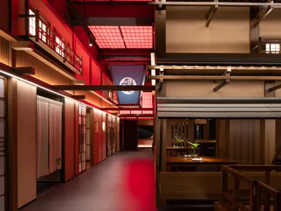 A modern restaurant interior with wooden elements and open spaces.