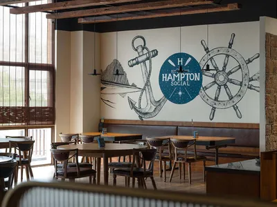 Industrial-themed restaurant interior with wooden tables, chairs, and beams