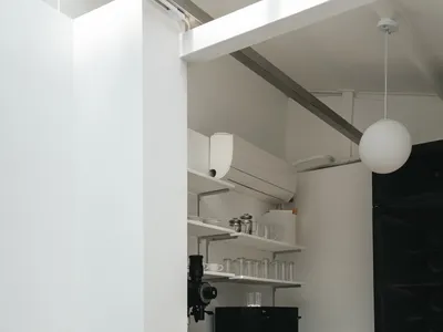 A modern minimalist kitchen featuring metal cabinets and countertops.