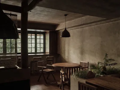 Modern restaurant interior featuring wooden tables and chairs with a warm, industrial ambiance