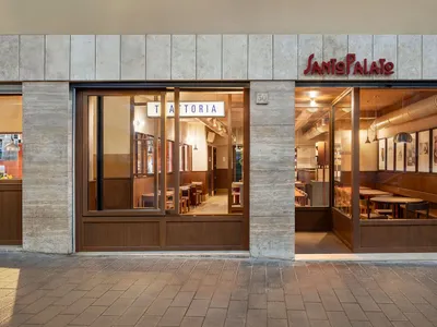 A cozy Italian trattoria with concrete walls and wooden furnishings.