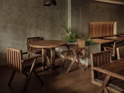 A modern restaurant interior featuring wooden furniture and a cozy ambiance.